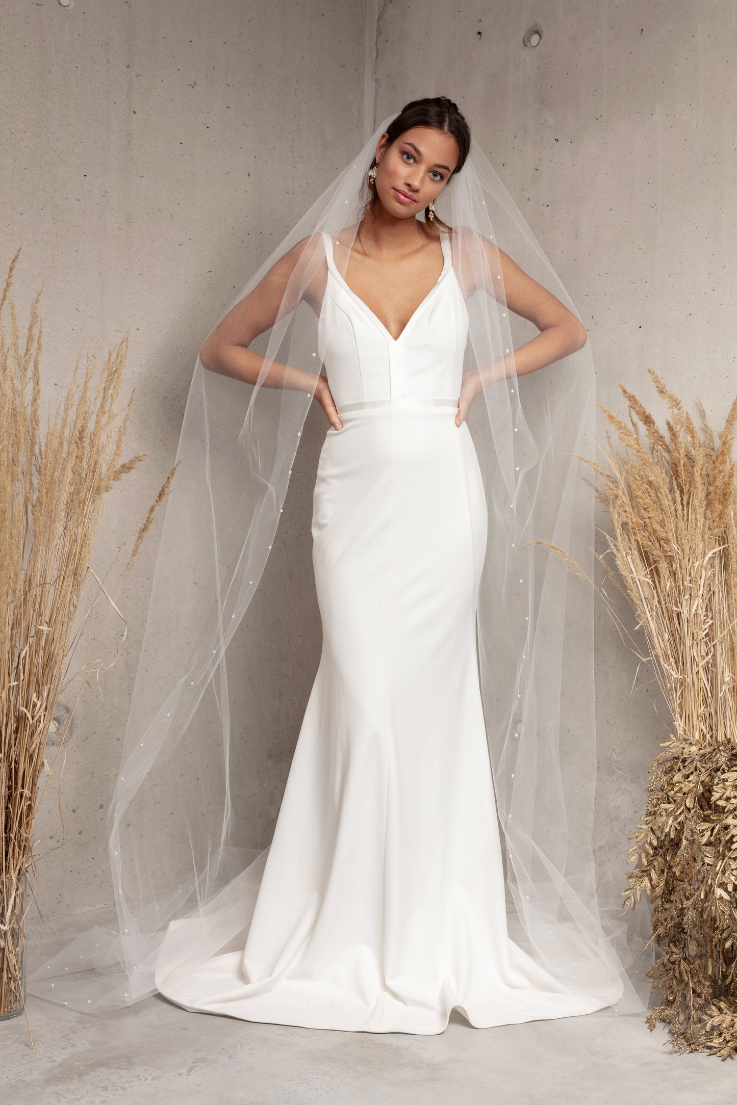 Complete your wedding look with our simply elegant MAJA VEIL. This classic piece features a delicately placed pearl edge in a linear pattern finished with voluminous gathering at the crown. Make a statement in the popular cathedral length or choose from shoulder, elbow, fingertip, floor, chapel, and royal lengths..