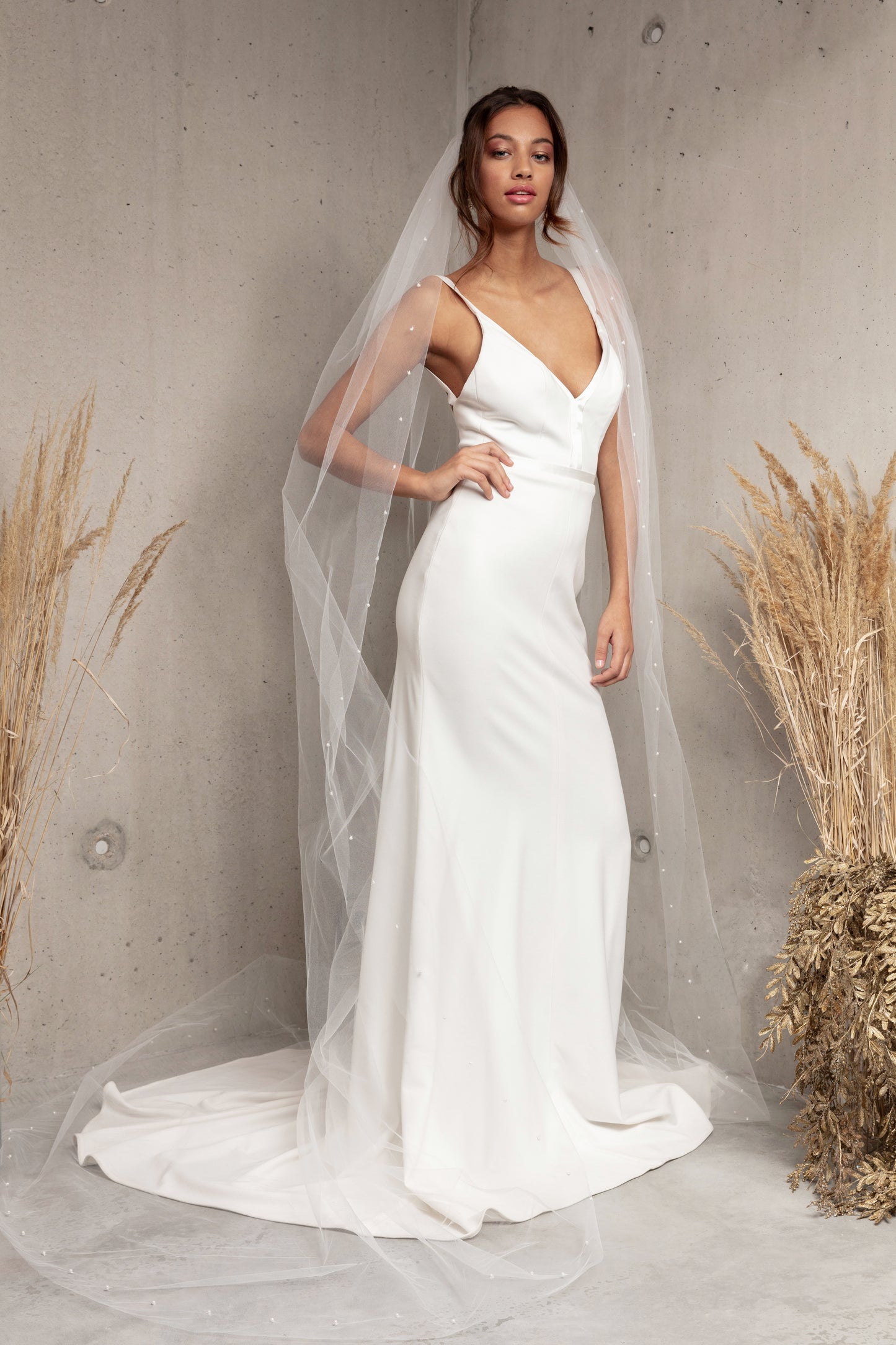 Complete your wedding look with our simply elegant MAJA VEIL. This classic piece features a delicately placed pearl edge in a linear pattern finished with voluminous gathering at the crown. Make a statement in the popular cathedral length or choose from shoulder, elbow, fingertip, floor, chapel, and royal lengths..