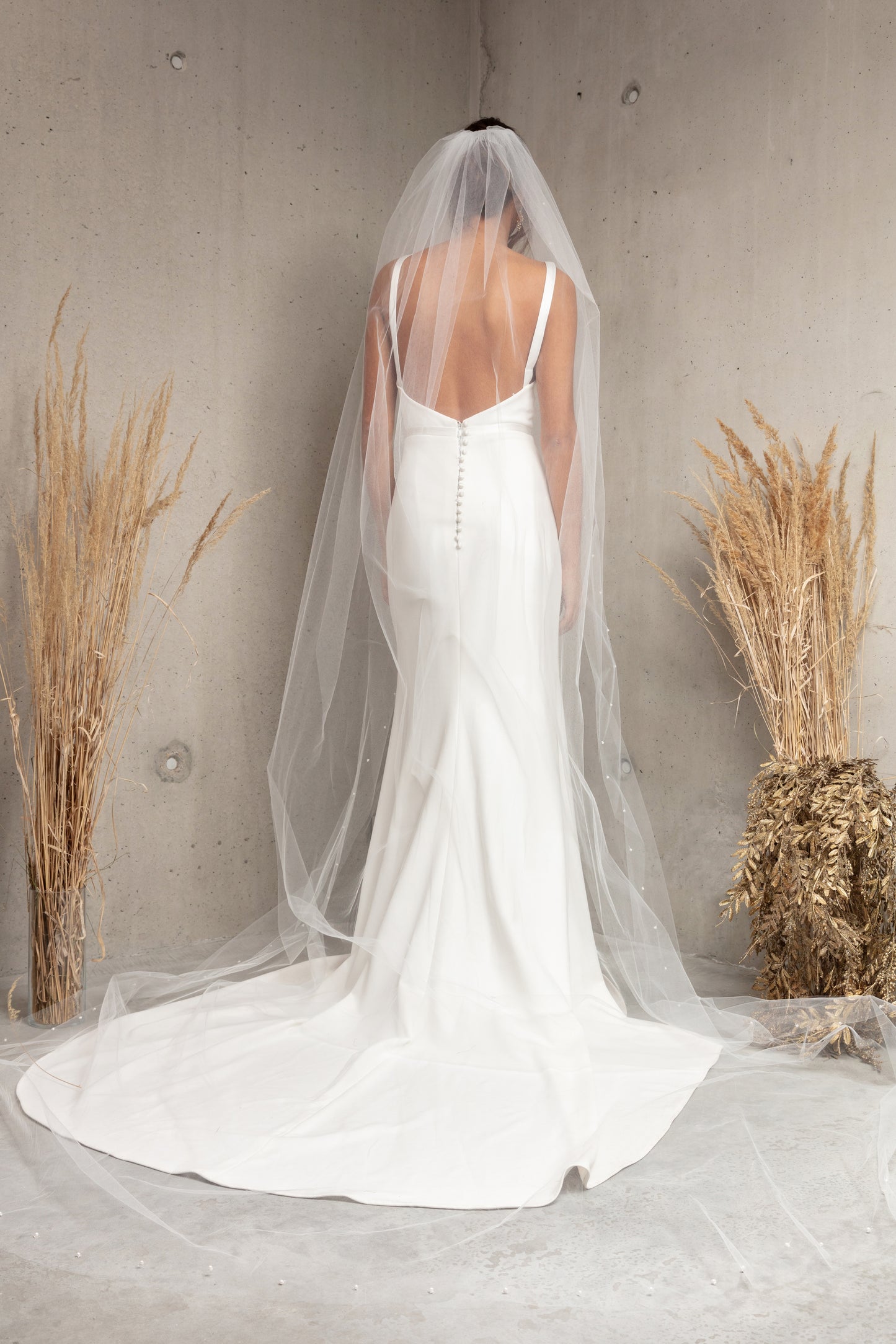 Complete your wedding look with our simply elegant MAJA VEIL. This classic piece features a delicately placed pearl edge in a linear pattern finished with voluminous gathering at the crown. Make a statement in the popular cathedral length or choose from shoulder, elbow, fingertip, floor, chapel, and royal lengths..